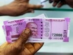 A woman holds <span class='webrupee'>₹</span>2000 notes as she exchanges demonetised notes at a bank in Chennai. A woman holds <span class='webrupee'>₹</span>2000 notes as she exchanges demonetised notes at a bank in Chennai.