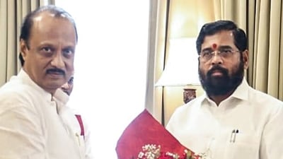 Maharashtra chief minister Eknath Shinde congratulates the newly sworn-in state deputy CM Ajit Pawar at Raj Bhavan in Mumbai on Sunday. (Eknath Shinde Twitter)