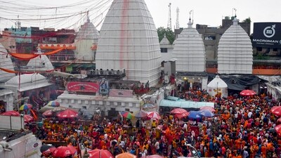 Devotees gather to offer prayers at Baba Baidyanath Dham on the occasion of Guru Purnima and the beginning of holy month of Shravan in Deoghar on Monday.&nbsp; (PTI)