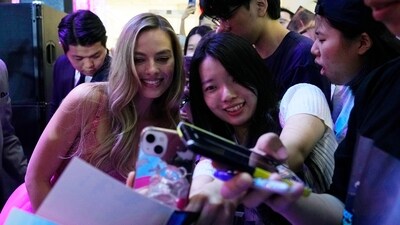 Margot Robbie takes a selfie with a fan during the pink carpet event for the movie Barbie in Seoul, South Korea on Sunday, July 2, 2023. The film stars Margot Robbie in the title role and Ryan Gosling as Ken.&nbsp; (AP)
