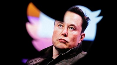 Elon Musk's photo is seen through a Twitter logo. (Reuters)