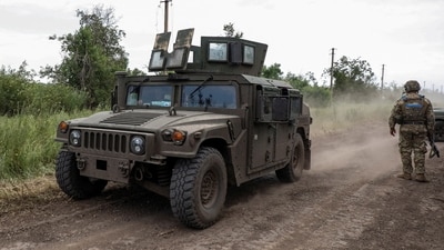 A HMMWV (Humvee) vehicle moves along a road near a the recently retaken village of Novodarivka, amid Russia's attack on Ukraine. (REUTERS)