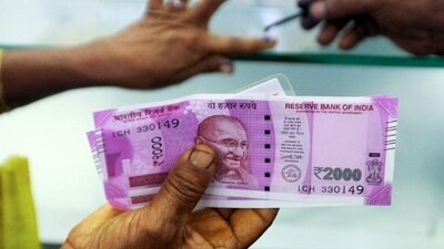 A woman holds  ₹2000 notes as she exchanges demonetised notes at a bank in Chennai. (AFP File Photo)