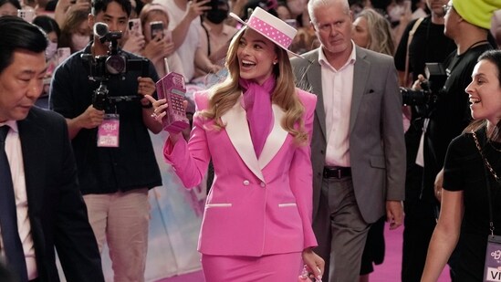 Margot Robbie's first designer look was a bright pink skirt suit with white details. Barbie, the movie, is based on the famous doll by Mattel and follows Barbie as she leaves Barbieland to heads to the real world.(AP)