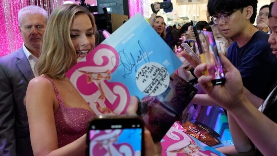 Margot Robbie signs the autographs for fans during the pink carpet event for the movie Barbie in Seoul. Warner Bros. had unveiled a first look at the Greta Gerwig film and its release date on Twitter in April 2022(AP)