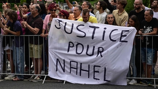 Spectator deploy a banner which reads "Justice for Nahel" along the race route at the start of the 1st stage of the 110th edition of the Tour de France cycling race, (AFP)