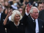 Britain's King Charles III (R) and Britain's Camilla, Queen Consort wave as they greet the crowd. Britain's King Charles III (R) and Britain's Camilla, Queen Consort wave as they greet the crowd.