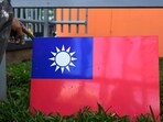 A worker holds Taiwan's flag. A worker holds Taiwan's flag.