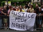 Spectator deploy a banner which reads "Justice for Nahel" along the race route at the start of the 1st stage of the 110th edition of the Tour de France cycling race,