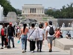 Visitors and tourists to the World War II Memorial shade themselves under umbrellas as temperatures reach into the 90's on July 03 in Washington, DC.