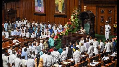 BJP MLAs shout slogans as they gather in well of the house during the state assembly session, at Vidhana Soudha in Bengaluru on Tuesday. (PTI) BJP MLAs shout slogans as they gather in well of the house during the state assembly session, at Vidhana Soudha in Bengaluru on Tuesday. (PTI)