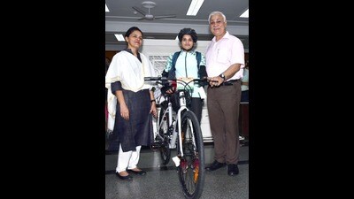 Chief secretary Durga Shankar Mishra presented a bicycle and sports kit to Madhya Pradesh athlete Asha Malviya at LDA office on Tuesday. (HT) Chief secretary Durga Shankar Mishra presented a bicycle and sports kit to Madhya Pradesh athlete Asha Malviya at LDA office on Tuesday. (HT)