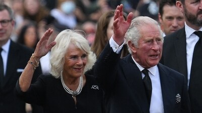 Britain's King Charles III (R) and Britain's Camilla, Queen Consort wave as they greet the crowd. (AFP) Britain's King Charles III (R) and Britain's Camilla, Queen Consort wave as they greet the crowd. (AFP)