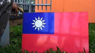 A worker holds Taiwan's flag. (AFP)