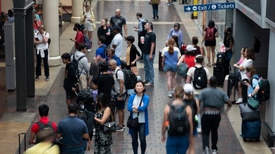 Fourth Of July: Travelers walk with their luggage through Union Station in Washington ahead of the Fourth of July holiday. (AP) Fourth Of July: Travelers walk with their luggage through Union Station in Washington ahead of the Fourth of July holiday. (AP)
