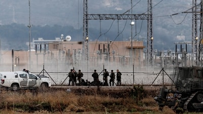Israeli forces stand near a fence, as an Israeli military operation continues on Jenin refugee camp in the Israeli-occupied West Bank. (REUTERS)