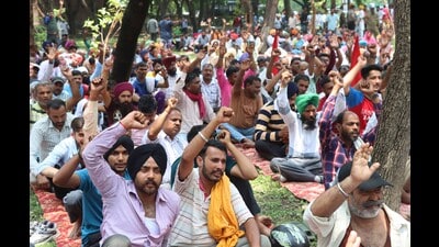Members of the Federation of UT Employees and Workers protesting near the Cricket Stadium in Sector 16, Chandigarh on Tuesday. (Keshav Singh/HT)