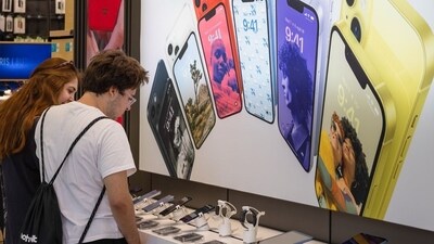 Shoppers look at Apple Inc. iPhone products in Stockholm. (Bloomberg file)