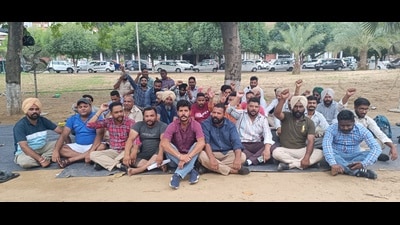 Security guards staging a protest outside the Thapar Hall on Tuesday. (HT Photo)