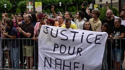 Spectator deploy a banner which reads "Justice for Nahel" along the race route at the start of the 1st stage of the 110th edition of the Tour de France cycling race, (AFP) Spectator deploy a banner which reads "Justice for Nahel" along the race route at the start of the 1st stage of the 110th edition of the Tour de France cycling race, (AFP)