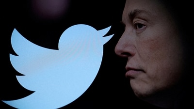 Twitter logo and a photo of Elon Musk are displayed through magnifier in this illustration. (REUTERS)