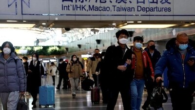 Travellers walk with their luggage at Beijing Capital International Airport. (Reuters) Travellers walk with their luggage at Beijing Capital International Airport. (Reuters)