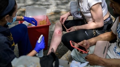 Registered nurse Jazmyna Fanini cleans the wound of drug user Crystal Mojica in a park in New York City on April 24, 2023. The tranquillizer, approved for veterinary use by the US Food and Drug Administration (FDA), has infiltrated the illegal drugs market in the US, with producers increasingly using it to augment fentanyl. Overdose deaths where tranq was detected have soared in recent years and in April the White House designated the drug an "emerging threat." (AFP) Registered nurse Jazmyna Fanini cleans the wound of drug user Crystal Mojica in a park in New York City on April 24, 2023. The tranquillizer, approved for veterinary use by the US Food and Drug Administration (FDA), has infiltrated the illegal drugs market in the US, with producers increasingly using it to augment fentanyl. Overdose deaths where tranq was detected have soared in recent years and in April the White House designated the drug an "emerging threat." (AFP)