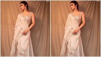 Mouni decked up in a sleeveless ivory white blouse with golden zari work, a matching flowy skirt and an ivory white dupatta with golden zari work at the borders. (Instagram/@imouniroy) Mouni decked up in a sleeveless ivory white blouse with golden zari work, a matching flowy skirt and an ivory white dupatta with golden zari work at the borders. (Instagram/@imouniroy)