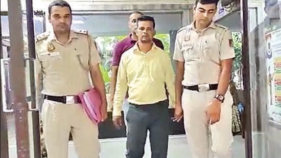 One of the two arrested employees of the showroom. (HT Photo)