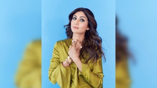 The ever-so-stylish Shilpa Shetty once again made headlines for her eye-grabbing wardrobe choice. She was earlier spotted stepping out in a comfy yet fancy outfit. She donned a satin green wrap asymmetrical dress which she paired with white sneakers.(Instagram/@theshilpashetty)