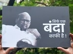 NCP Sharad Pawar faction supporter shows a placard during the party leaders meeting at YB Chavan centre in Mumbai on Wednesday. (ANI Photo) NCP Sharad Pawar faction supporter shows a placard during the party leaders meeting at YB Chavan centre in Mumbai on Wednesday. (ANI Photo)