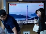 A TV screen shows a file image of North Korea's rocket launch during a news program, at the Seoul Railway Station in Seoul.