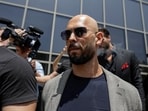 FILE PHOTO: Andrew Tate, escorted by bodyguards, leaves the Bucharest Tribunal in Bucharest, Romania, June 21, 2023. Inquam Photos/Octav Ganea via REUTERS   ATTENTION EDITORS - THIS IMAGE WAS PROVIDED BY A THIRD PARTY. ROMANIA OUT. NO COMMERCIAL OR EDITORIAL SALES IN ROMANIA/File Photo