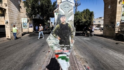 A picture of Jamil al-Amouri, the late founder of the Jenin Brigades Palestinian militant group, is displayed on a cutout depicting a map of historical Palestine outside the archway, marking the entrance to the Jenin camp for Palestinian refugees in the north of the occupied West Bank, after the Israeli army declared the end of a two-day military operation in the area, on July 5. (Ahmad Gharabli / AFP) A picture of Jamil al-Amouri, the late founder of the Jenin Brigades Palestinian militant group, is displayed on a cutout depicting a map of historical Palestine outside the archway, marking the entrance to the Jenin camp for Palestinian refugees in the north of the occupied West Bank, after the Israeli army declared the end of a two-day military operation in the area, on July 5. (Ahmad Gharabli / AFP)