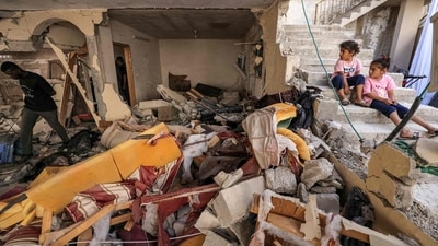 Children sit along a staircase by the rubble and broken furniture of a destroyed flat in a building in the occupied West Bank city of Jenin, after the Israeli army declared the end of a two-day military operation in the area. Residents of the Jenin refugee camp emerged from their homes to find alleys lined with piles of rubble and flattened or scorched cars. Shopkeepers and bulldozers started clearing the debris and thousands who had fled the fighting began returning, AP reported. (Ahmad Gharabli / AFP) Children sit along a staircase by the rubble and broken furniture of a destroyed flat in a building in the occupied West Bank city of Jenin, after the Israeli army declared the end of a two-day military operation in the area. Residents of the Jenin refugee camp emerged from their homes to find alleys lined with piles of rubble and flattened or scorched cars. Shopkeepers and bulldozers started clearing the debris and thousands who had fled the fighting began returning, AP reported. (Ahmad Gharabli / AFP)