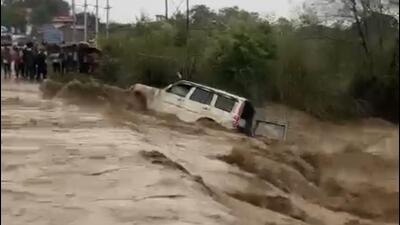 A video grab of a vehicle being swept away in a tributary of the Swan river after a flash flood in Haroli sub division of Una district on Wednesday.