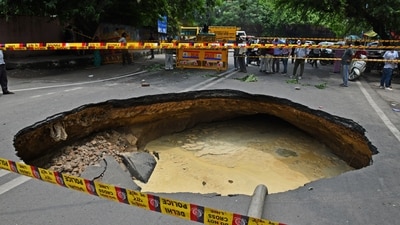Police demarcated the area where a large portion of the road has caved in due to heavy rainfall, at Janakpuri. (ANI) Police demarcated the area where a large portion of the road has caved in due to heavy rainfall, at Janakpuri. (ANI)