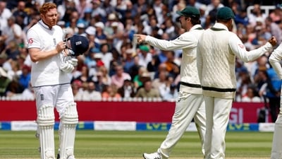 Travis Head points as he talks with Jonny Bairstow during the second Ashes Test (AFP)