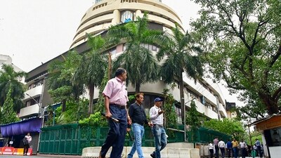 Pedestrians walk past the Bombay Stock Exchange (BSE) building, in Mumbai, (PTI) Pedestrians walk past the Bombay Stock Exchange (BSE) building, in Mumbai, (PTI)
