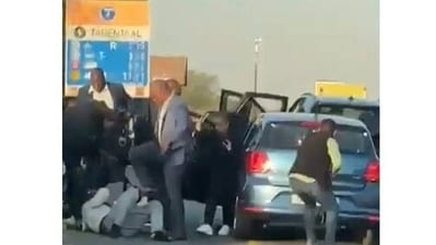 South Africa: In the video, the officers were seen holding rifles and dragging the man across the road. South Africa: In the video, the officers were seen holding rifles and dragging the man across the road.