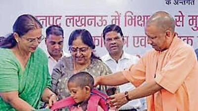 Uttar Pradesh chief minister Yogi Adityanath distributing educational material to a child in Lucknow on Wednesday. (HT PHOTO) Uttar Pradesh chief minister Yogi Adityanath distributing educational material to a child in Lucknow on Wednesday. (HT PHOTO)