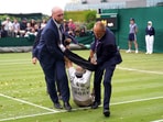 A Just Stop Oil protester is taken off court 18 after throwing confetti on to the grass during a Wimbledon match A Just Stop Oil protester is taken off court 18 after throwing confetti on to the grass during a Wimbledon match