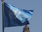The flag of the United Nations flutters.