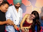 Ameesha Patel poses with filmmaker Anil Sharma at a promotional event for their film Gadar : Ek Prem Katha.