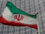 An Iranian flag flutters in front of the International Atomic Energy Agency (IAEA) headquarters in Vienna, Austria.