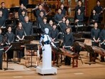 The robot is guiding the musicians of South Korea's national orchestra during a concert at the national theatre in Seoul. The robot is guiding the musicians of South Korea's national orchestra during a concert at the national theatre in Seoul.