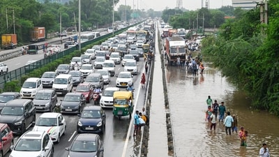 Traffic congestion at National Highway-48 due to heavy monsoon rain showers and waterlogging near Narsinghpur village, in Gurugram, India, (Photo by Parveen Kumar/Hindustan Times)