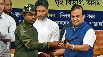A tribal militant lays down arms in the presence of Assam chief minister Himanta Biswa Sarma during a ceremony in Guwahati on Thursday. (ANI) A tribal militant lays down arms in the presence of Assam chief minister Himanta Biswa Sarma during a ceremony in Guwahati on Thursday. (ANI)