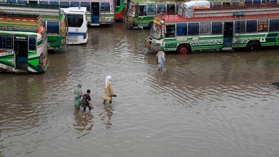 Passengers wade through a flooded bus terminal caused by heavy monsoon rainfall in Lahore, Pakistan, Wednesday. (AP) Passengers wade through a flooded bus terminal caused by heavy monsoon rainfall in Lahore, Pakistan, Wednesday. (AP)