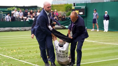 A Just Stop Oil protester is taken off court 18 after throwing confetti on to the grass during a Wimbledon match (AP) A Just Stop Oil protester is taken off court 18 after throwing confetti on to the grass during a Wimbledon match (AP)